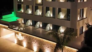 A multi-story hotel with a modern design, featuring illuminated windows and a prominent sign for 'PADMA HOTEL & SPA'. - Padma Hotel (Vlorë)