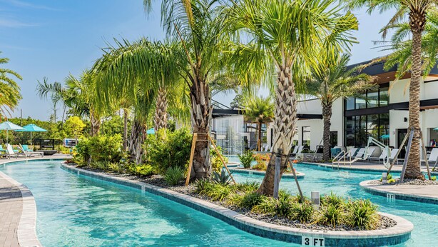 A swimming pool with palm trees and lounge chairs. - Modern Getaway w/Game Room + Pvt Pool + BBQ Near Universal and I-Drive (Orlando)