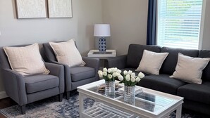 A living room with a sofa, armchairs, a coffee table, and a rug. -  Deer Sanctuary Pasture Views & Total Relaxation (Statham)