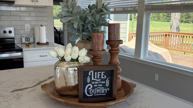 A kitchen counter with a decorative centerpiece, a sign with a quote, and a house rules sign. -  Deer Sanctuary Pasture Views & Total Relaxation (Statham)