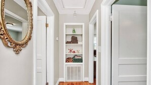 A hallway with white walls, a wooden floor, and a white door on the right. - Cottage, Great Location Downtown / Airport 4 beds (Nashville)