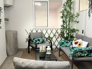 A modern living room with a sofa, armchair, and a coffee table. - Apartment CASA ÑEÑE by KHOUSE VACATION (Puerto de la Cruz)