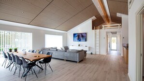 A modern interior with a dining area, sofa, TV, and a staircase. - Gorgeous home in Sæby with sauna (Sæby)