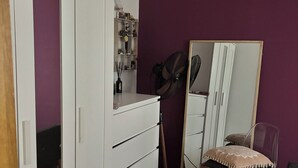 A room with a wardrobe, a mirror, a chair, and a fan. - Cozy apartment in a vibrant neighborhood  with fast internet (Skopje)