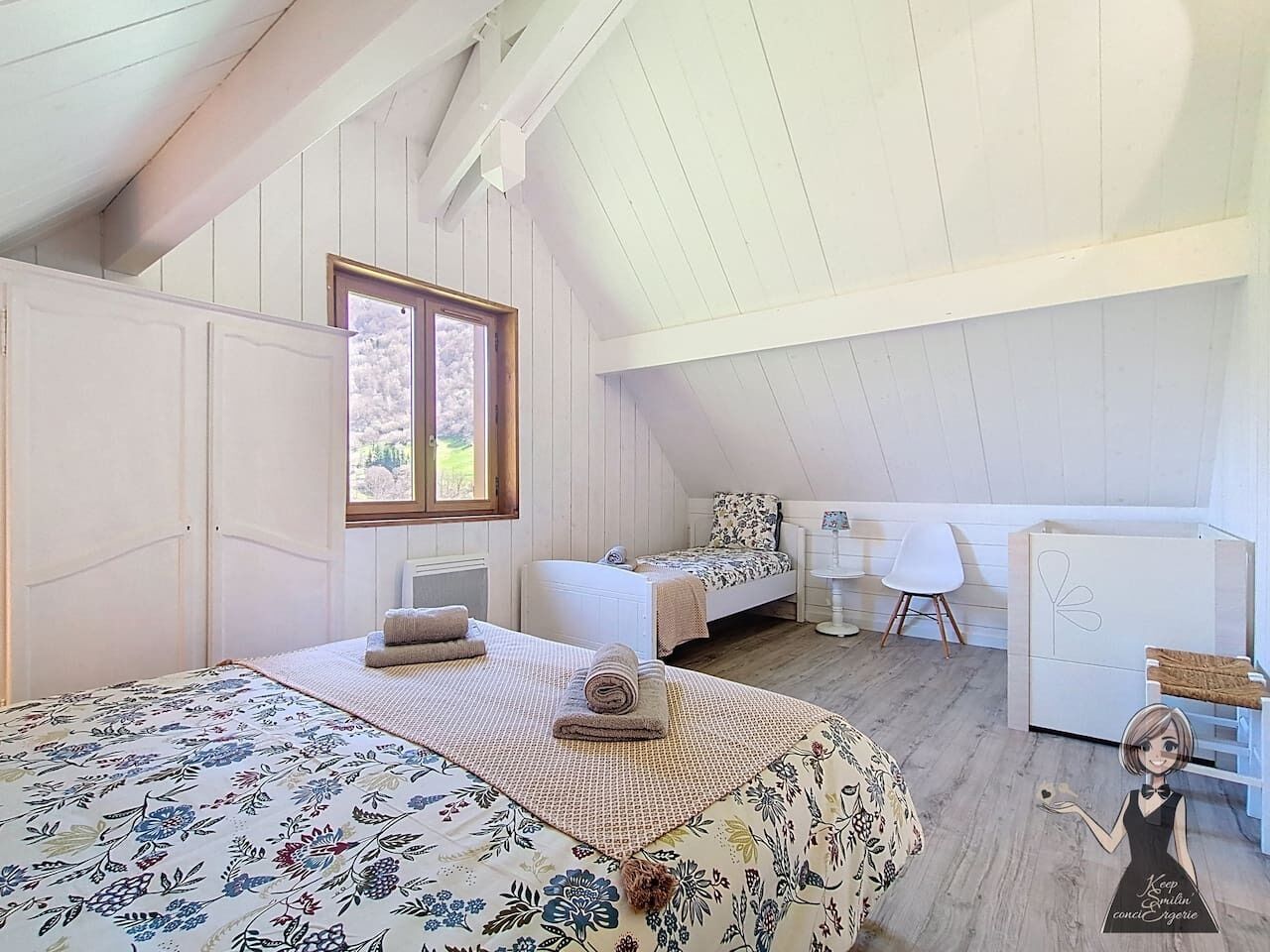 A bedroom with a large bed, a bedside table, a chair, and a small desk.
