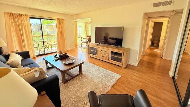 A spacious living room with a sofa, coffee table, TV, and a view to the outside. - Elevator, Private Parking
Balcony, CalKingBed
Entire rental unit in Wanut creek (Walnut Creek)