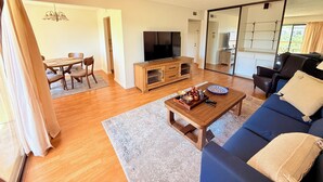 A living room with a sofa, coffee table, TV, and dining area. - Elevator, Private Parking
Balcony, CalKingBed
Entire rental unit in Wanut creek (Walnut Creek)