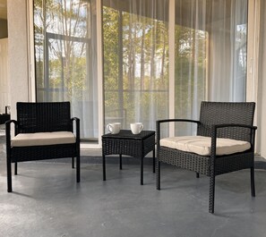 A room with two wicker chairs and a small table, both with cushions, near large windows with sheer curtains. - Sandestin, 1 BR/2 Bath, Sleeps 4, Golf Cart Available! (Miramar Beach)