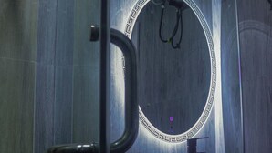 Un baño con espejo, lavabo y puerta.