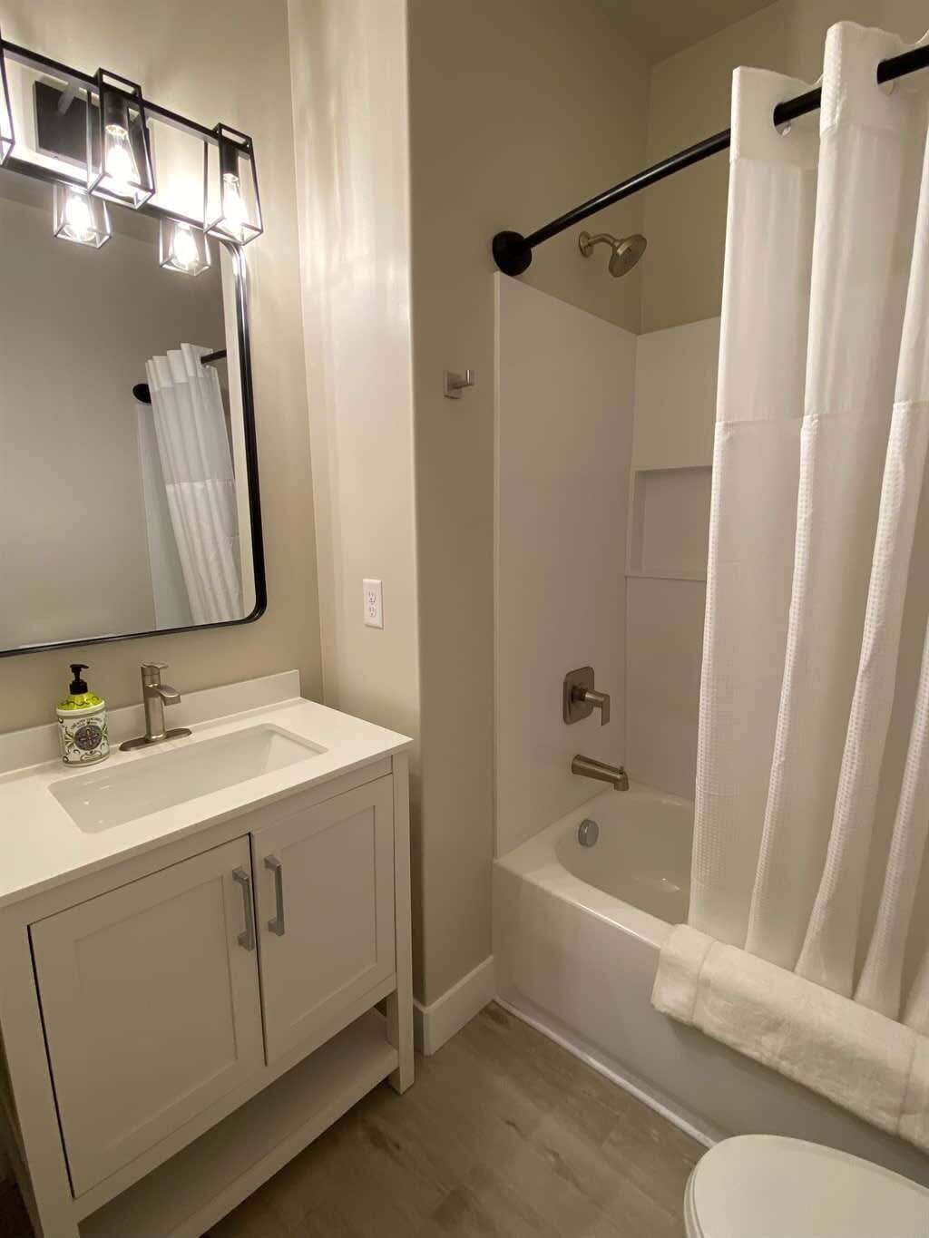 Shower, hair dryer, towels, shampoo