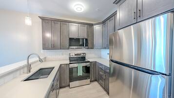 Kitchen with a stainless fridge and range