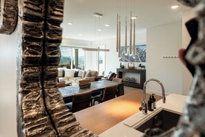 A modern kitchen with a wooden island, stainless steel sink, and pendant lighting. - Experience luxury at Park City Apex 207, a 3-bedroom ski-in/ski-out condo in Canyons Village. (Park City)
