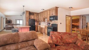 A spacious living area with a kitchen, a sofa, and a dining table.