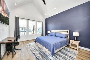 A bedroom with a bed, bedside tables, a desk, and a chair. - Walk to World Cup Fan Fest!  New 3BR Luxe Home, Hot Tub, Min Stadiums, Sleeps 10 (Houston)