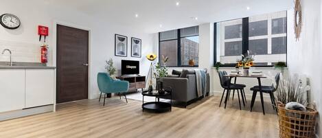 A modern apartment with a kitchen, dining area, and living room.