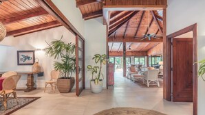 A spacious interior with high ceilings, wooden beams, and a central open area with seating. - 5br Villa Nearby the Beach w Pool in Casa de Campo (La Romana)