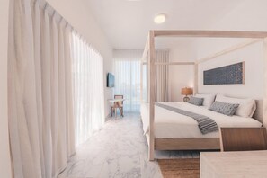 A hotel room with a bed, a small table, a chair, a lamp, and a painting on the wall. - 3br-penthouse w Jacuzzi Incl at Lake View (Las Terrenas)