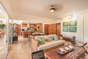 A spacious living area with a sofa, a dining table, and a kitchen in the background. - Private Terrace 3br 6 Guests Beach Access (Las Terrenas)