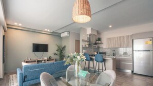 A modern living room with a sofa, a glass coffee table, and a TV. - Regatta Living Ii - 705 (Santo Domingo)