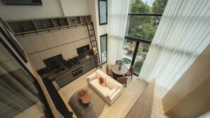 A modern living area with a kitchen, a dining table, and a sofa. - Relaxing 2br Apt at Coco del mar (Panama City)