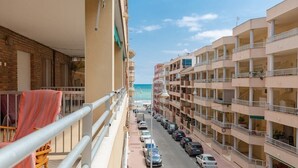 A multi-story hotel with balconies overlooking a street and the ocean. - Fidalsa Bay View Romance (Guardamar del Segura)