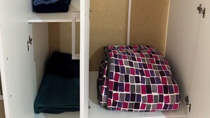 A wardrobe with hanging space, shelves, and a folded bed. - Apt. with double bed and patio 20 min. from the historical center (Heroica Puebla de Zaragoza)