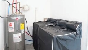 A room with a water heater, a covered object, and a light fixture. - 12 Min to Mercedes-Benz Stadium  2BR Sleeps 5  4 Min to MARTA (East Point)