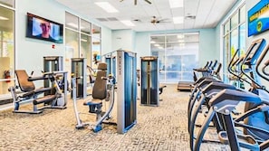 A gym with exercise equipment, a television, and large windows. - Windsor Island | 5 Br 14ppl | Pool, WATER PARK (Davenport)
