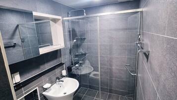 Shower, hair dryer, towels, toilet paper