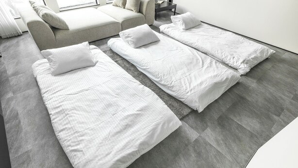 A modern hotel room with a grey tiled floor, two single beds with white linens, a grey sofa, and a small table. - Charm Roger luxury room Bridge (Kamakura)