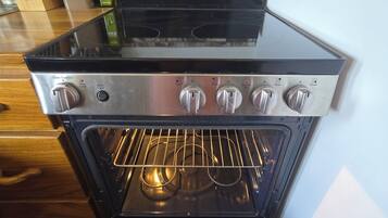An oven with a control panel, a stovetop, and a glass door.