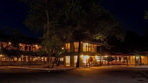 A two-story building with a central patio area, large windows, and a flat roof. - Gimanhala Hotel (Dambulla)