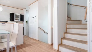 A modern interior with a kitchen, dining area, and a staircase. - 4min to Station 3LDK Takadanobaba (Tokyo)