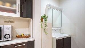 A compact kitchenette with a microwave, toaster, and a small plant on the counter. - 4min to Station 3LDK Takadanobaba (Tokyo)