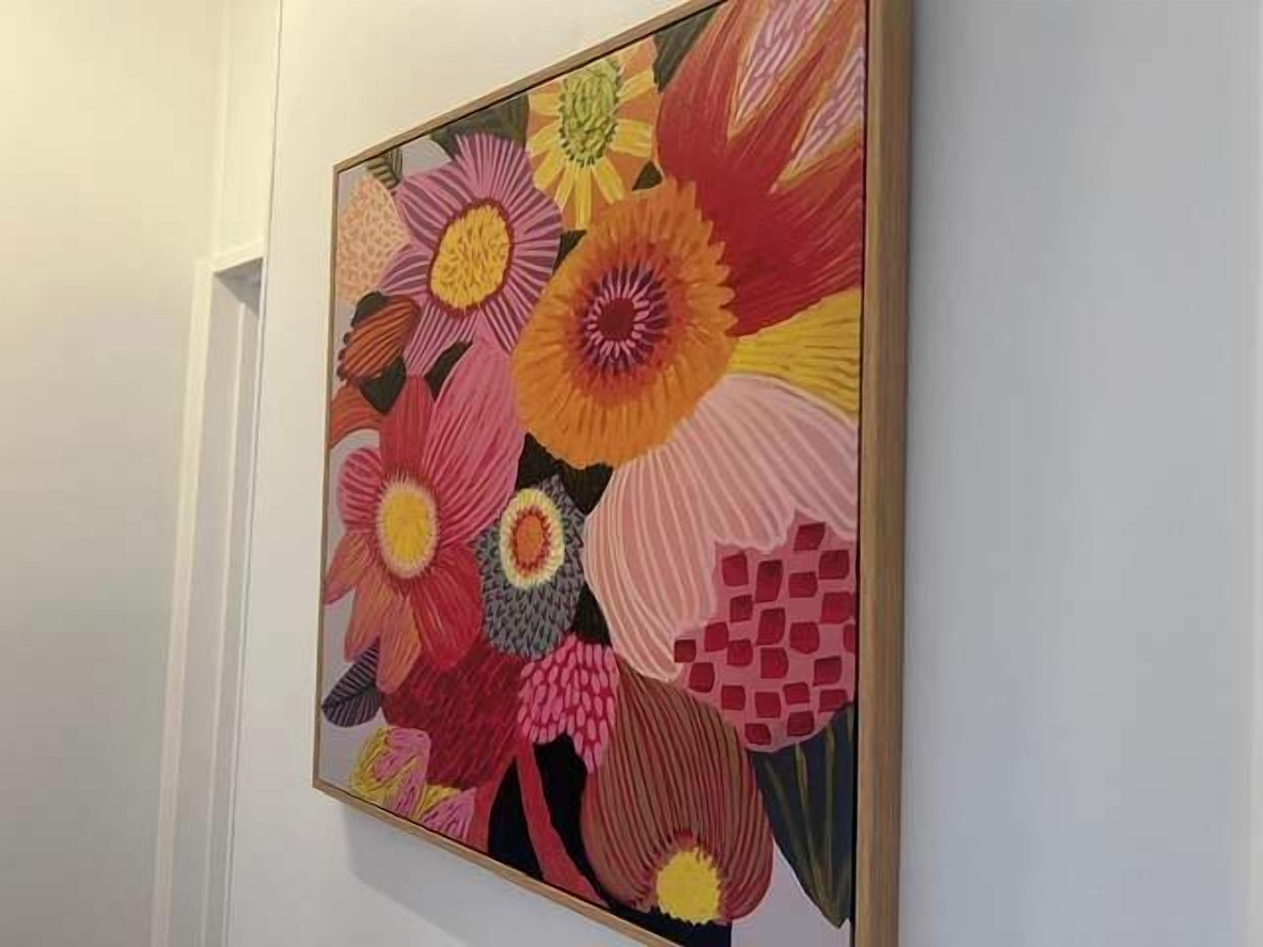 A framed floral artwork on a wall.