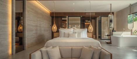 A modern bedroom with a large bed, a sofa, a bathtub, and a walk-in closet.