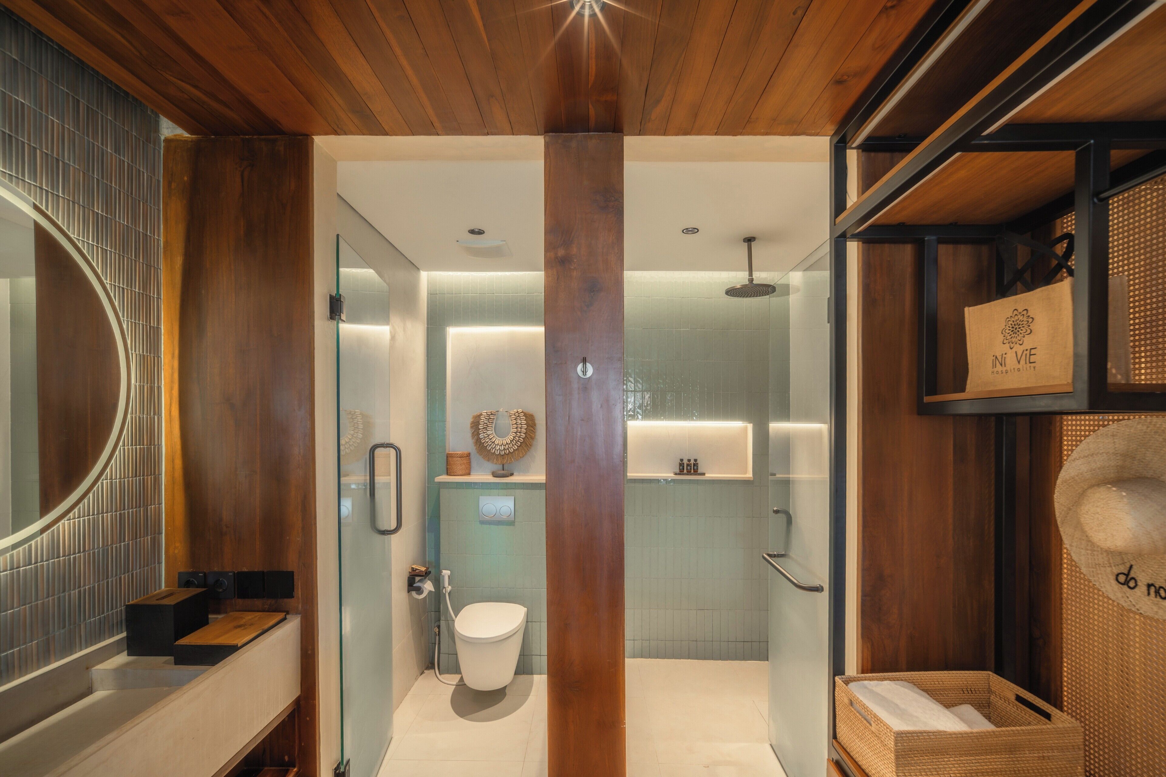 A modern bathroom with a wooden ceiling, a glass shower enclosure, and a visible toilet.