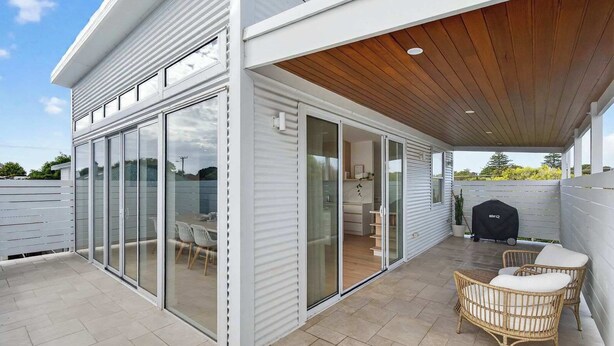 A modern house with a covered patio, sliding glass doors, and outdoor furniture. - 15A Charteris St, Port Elliot Walk to Horseshoe Bay (Port Elliot)