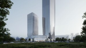 Ein modernes Gebäude mit außergewöhnlichem architektonischen Design, bestehend aus zwei hohen Strukturen mit vertikalen Linien und einer geschwungenen Basis.