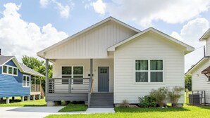 A single-story house with a front porch, a garage, and a small front yard. - 111 Lavish Bungalow 1753! Medical Center, Stadiums (Houston)