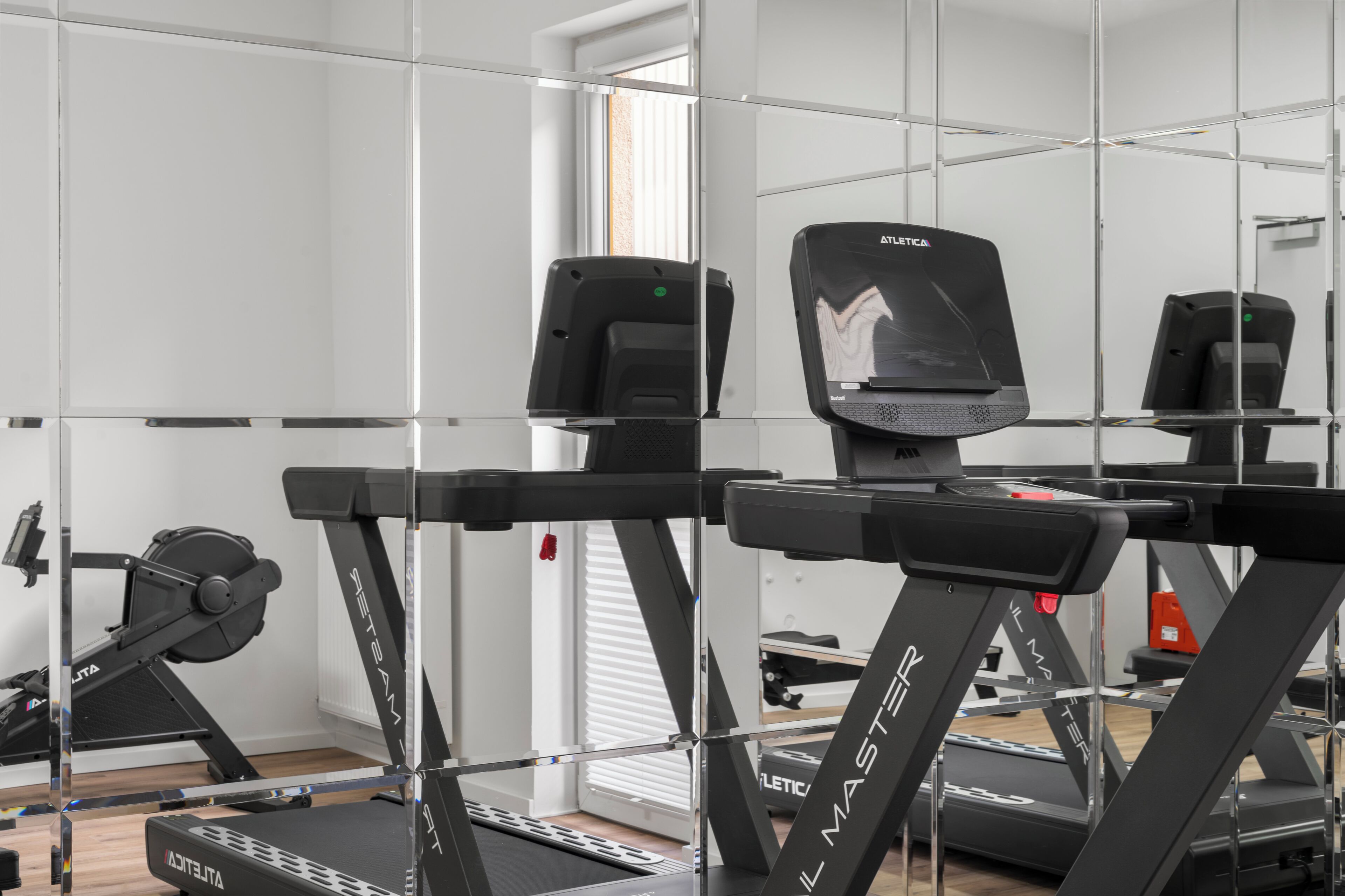 A gym with treadmills and exercise equipment.