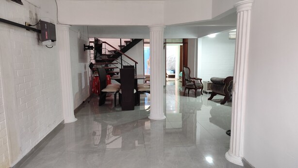 A spacious living area with a staircase, a dining area, and a seating area with a view. - Beautiful house in Cartago Valle (Cartago)
