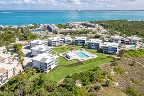 Ein Resort mit mehreren Gebäuden, einem Schwimmbad und Blick aufs Meer.