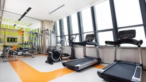 A gym with treadmills, elliptical machines, and weight equipment. - Home2 Suites By Hilton Beijing Shunyi  (Shunyi)