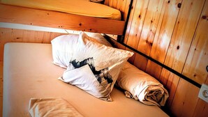 A room with two bunk beds, wooden walls, a small black object on the wall, and a white switchboard. - Room-charming Guest Room in Ebbs Austria (Ebbs)