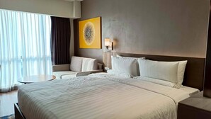 A hotel room with a large bed, a sofa, a small round table, and a large window with curtains. - Lerfo Staycation!!!! (Mandaluyong City)