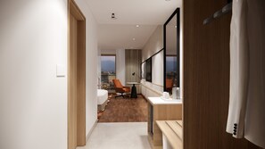 A modern hotel room with a wooden floor, a desk with a chair, a large window, and a view of the city.