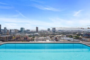A rooftop pool with a cityscape view, including high-rise buildings and a bridge. - Four Seasons Urban Escape (Cape Town)