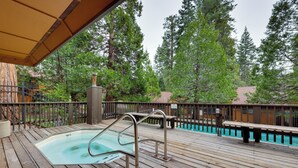 A wooden deck with a hot tub, metal railings, and a pool. - 1 Mi to Shaver Lake! Family & Couples Condo (Shaver Lake)