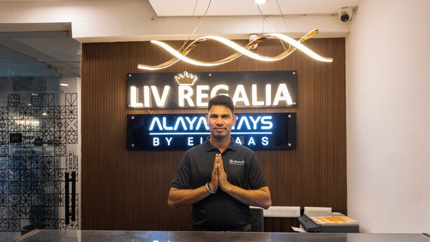 A reception desk with a sign that reads 'LIV REGALIA' and 'ALAYAYS BY ELIAAS'.